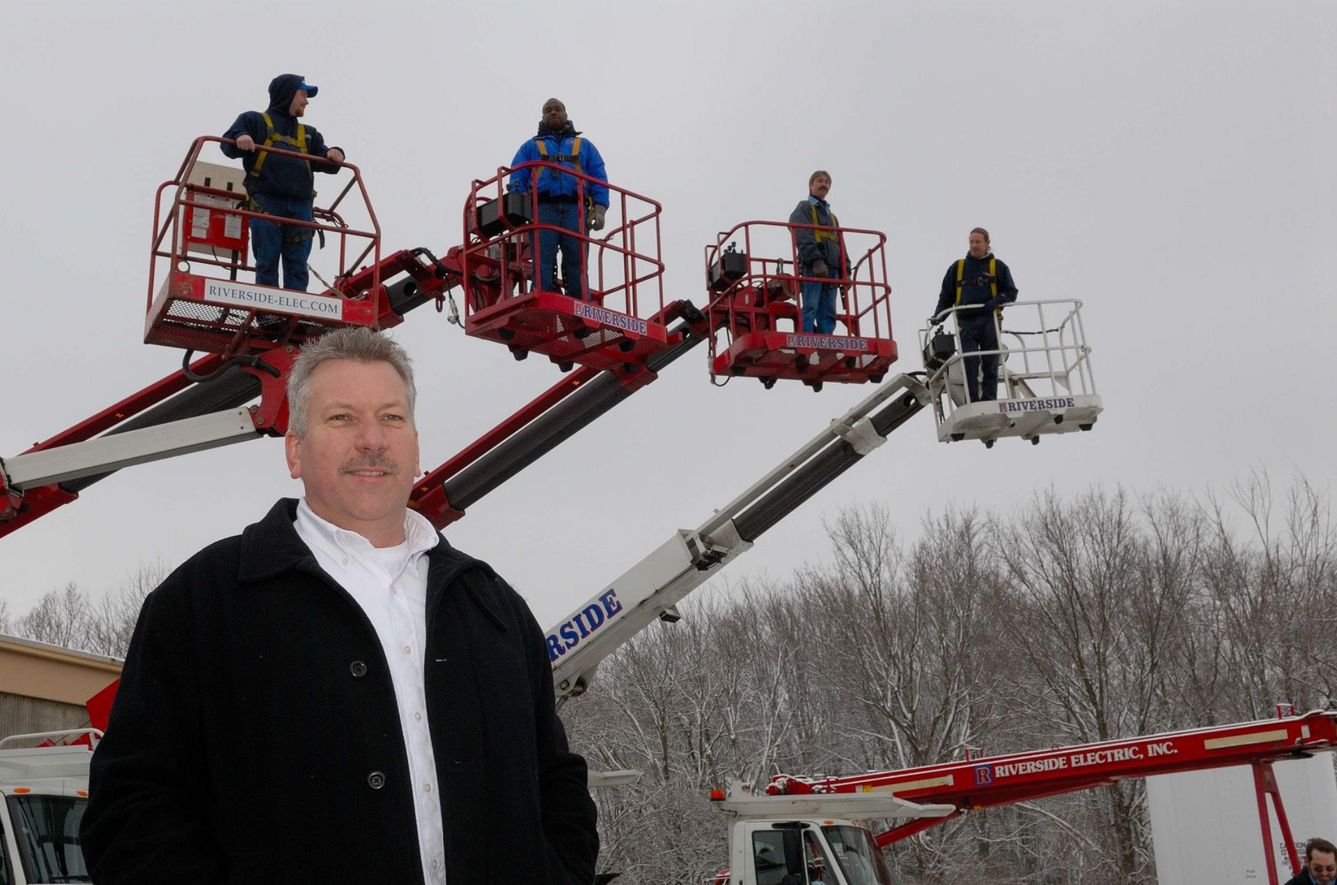 Riverside Electric team with bucket trucks